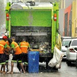 Colombo Rain or shine: Garbage collectors carry on working in the heavy rains.