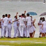 Galle Face: Fair weather: A group of students enjoy the rainy skies.