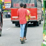 Aluthkade- Small wheels: Hitching a ride on a skateboard unsuited for a main road.