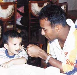 Dad's the word: Hashan Tillekeratne lends a helping hand to his son