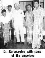 Dr. Karunaratne with some of the amputees