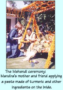 The Mehendi ceremony: Mandira's mother and friend applying a paste made of turmeric and other ingredients on the bride.