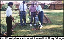 Ms. Wood plants a tree at Ranweli Holiday Village