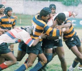 A Kandy forward is smothered by the Army forwards.