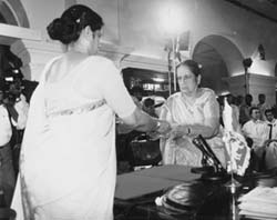 Being sworn in by her daughter as Prime Minister for the time