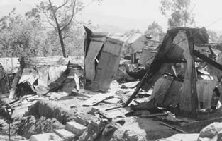 Burnt down makeshift sheds at the camp