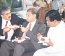 Finance Minister Choksy flanked by the IMF's Colombo Chief Nadeem-Ul-Haq and Deputy Finance Minister Bandula Gunawardena in parliament on Friday