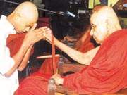 The Mahanayake of the Amarapura Sangha Sabhawa, Ven Madihe Pannaseeha Mahanayake Thera who marks his 90th birthday tomorrow on Poson Poya day ordains one of the young boys. A series of religious celebrations were held to invoke blessings on the Mahanayake thera and will be continued tomorrow. Pic by Ranjith Perera