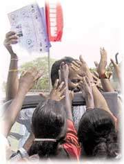 Residents throng to collect glossy product brochures at war-battered northern Jaffna's first trade fair yesterday. About 70 companies from the south of Sri Lanka set up stalls in a partly bombed out school in Jaffna, encouraged by a five-month ceasefire in the 20-year war between the government and Tamil Tiger guerrillas. - Reuters 