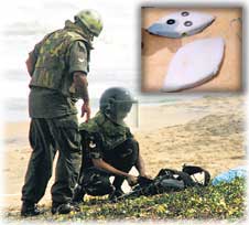 Security personnel at the Pamunugama beach on June 17, 2006