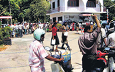 Hundreds of people carrying plastic cans standing in queues at Jaffna filling stations.