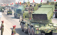 Military trucks carrying multi-barrel rocket launchers on Independence Day rehearsal.