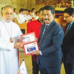 The first-day cover being presented to Bishop Keerthi Fernando by Deputy Post Master General Rajitha Ranasinghe