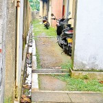 Drains surrounding the  post office are blocked with empty soda bottles, beer cans and bags