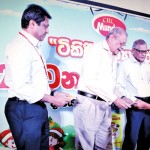 Ramya Wickramasingha ,Group Chairman of CBL(Center) handing over  Shishyadara to a Munchee Tikiri Shishyadara recipient.Also in the picture are Nalin . B .Karunaratne ,Director/CEO and Jayampathi Bandaranayake , Group Director of CBL