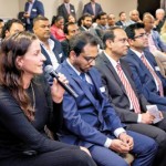 A participant at the forum poses a question to the panel.