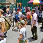 STAJ-01---A-foreign-family-waring-a-cap-at-the-Pettah-market.