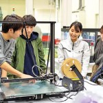 Students at a practical training with  3D printers.
