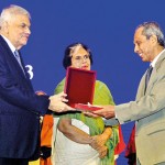Ambassador H M G S Palihakkara receiving a token of appreciation