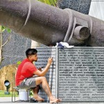 Galle Face Re-writing: An engraver paints the description under a canon