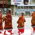 Fort:On a path: Young monks cross a road