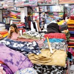 Whether it was for fabrics and garments (above) or grocery shopping (below) for the New Year, there were mixed reactions from shoppers and vendors alike. Pix by M.A. Pushpa Kumara