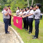 Professor Ranjith Pallegama  placing the Rover Investiture Scarf on a Rover member.