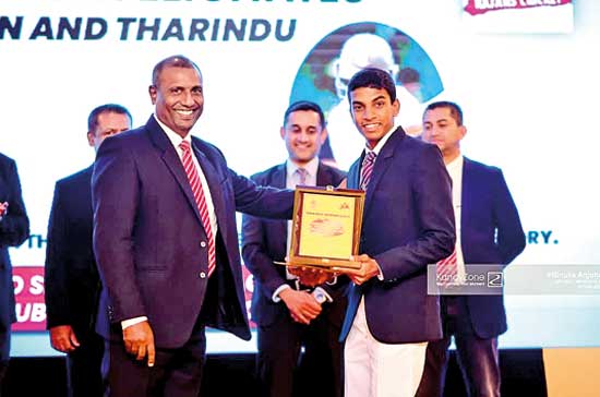 Tharindu-Warnakulage-receiving-his-award-from-Thanuja-Godewatte,-President-of-Dharmaraja-College-Cricket-Foundation_BP