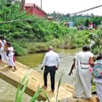 A group of Daham Pasal students using the broken bridge
