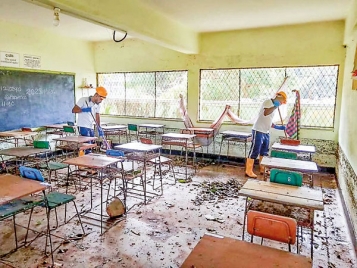 Volunteers clean muddy classrooms
