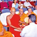 A presentation to the senior Member of Asgiriya Sanha Sabha Venerable Panitha Premartne and on his left are the Anunayake of Asgiriya Venerable Panditha Wenduruawa Upali Thera and Rajakeeya Panditha Niyangoda Vijitha Siri Thera