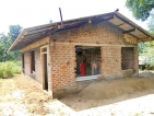 Retired professor Ven Okkampitiya Pannasara Nayaka Thera builds homes for the needy