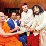 H Authors present the first copy of the book to Ven Prof Gallelle Sumanasiri Thera.
