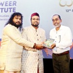 I Authors present the book to Minister Sunil Senevi.