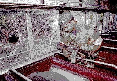 an STF commando inspects the bus that came under LTTE fire...