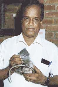 Dr. Kandasamy with a baby monkey
