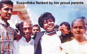 [Susanthika flanked by her proud parents]
