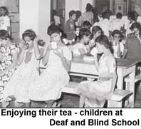Enjoying their tea - children at Deaf and Blind School