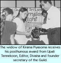 The widow of Kirama Piyasoma receives his posthumous award from Upali Tennekoon, Editor, Divaina and founder secretary of the Guild.