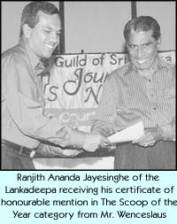 Ranjith Ananda Jayesinghe of the Lankadeepa receiving his certificate of honourable mention in The Scoop of the Year category from Mr. Wenceslaus