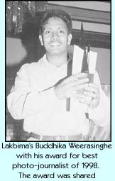 Lakbima's Buddhika Weerasinghe with his award for best photo-journalist of 1998. The award was shared