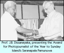 Prof. J.B. Disanayaka, presenting the Award for Photojournalist of the Year to Sunday Island's Saranapala Pamunuwa