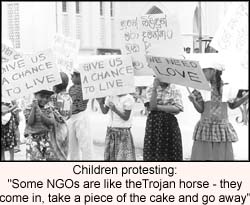 Children protesting: Some NGOs are like the Trojan horse - they come in, take a piece of the cake and go away,