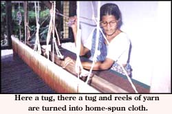 Herea tug, there a tug and reels of yarn are turned into home-spun cloth.